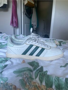 White adidas with green stripes